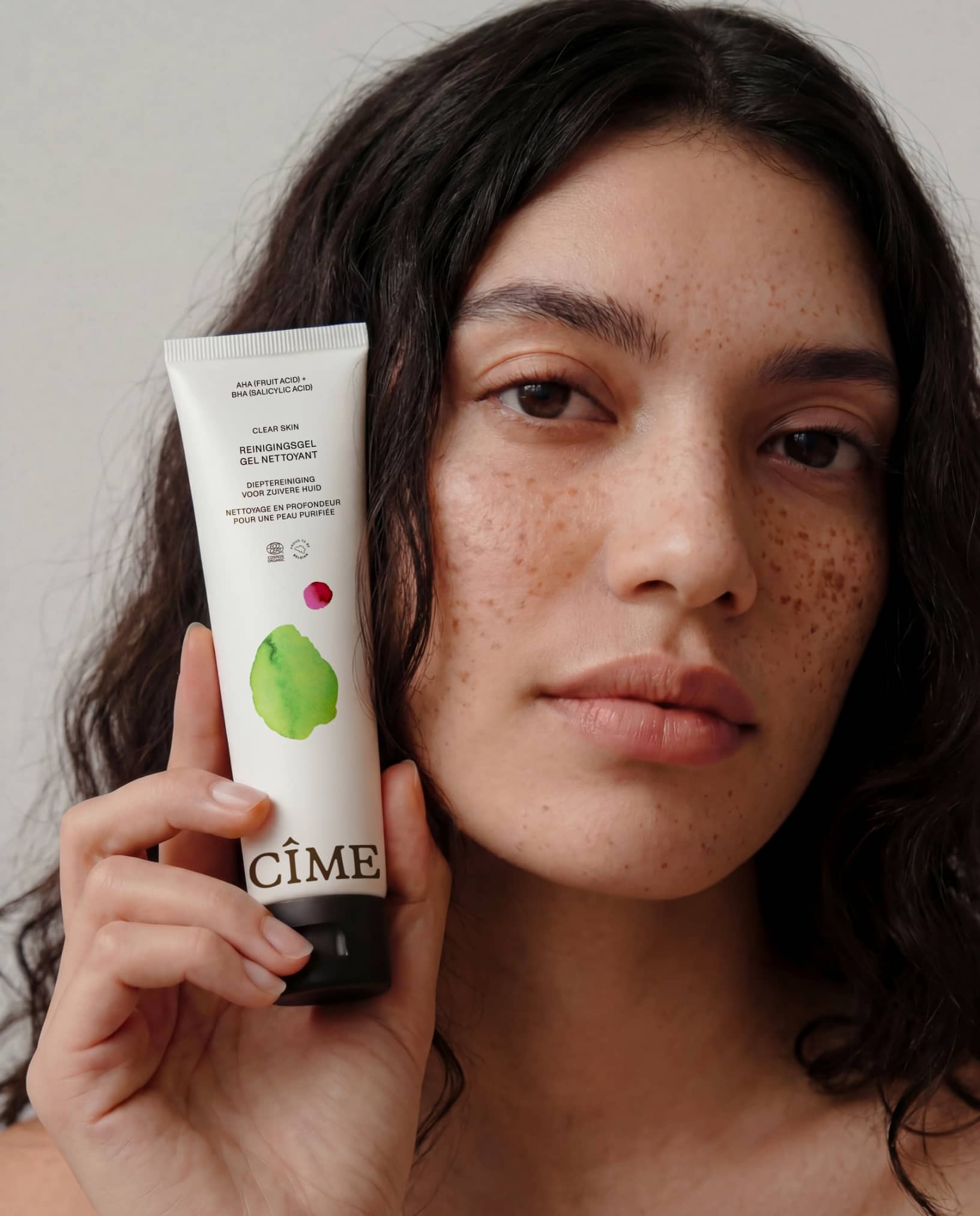 cime-ai-skincare-model-holding-cleanser-the-phoney-club